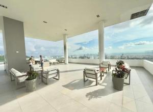 a balcony with benches and tables on a building at Tu apartamento en la playa piso 10 in Cartagena de Indias