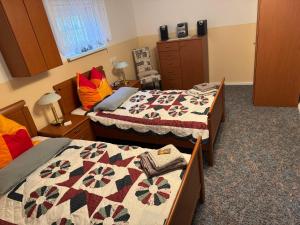 a bedroom with two beds and a quilt at Gästezimmer Neumann in Bad Münder am Deister
