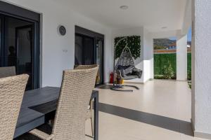 a dining room with a table and chairs at Villa Mine Blagaj in Blagaj