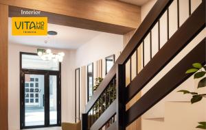 a hallway of a house with a staircase and a sign at Vita Home Lanzarote I Deluxe Apartments in Arrecife