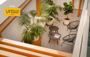 an overhead view of a table and chairs and plants at Vita Home Lanzarote I Deluxe Apartments in Arrecife +34 photos
