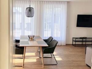 a dining table and chairs in a living room at WeberHof Appartements in Burg +18 photos