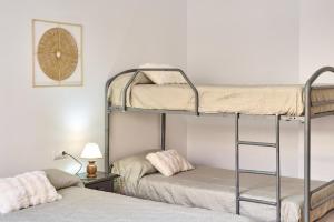 a bedroom with two bunk beds and a lamp at Seralva Rural Zuheros in Zuheros