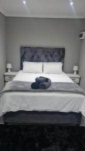 a bedroom with a large bed with two night stands at Magents the Farm in Paarl