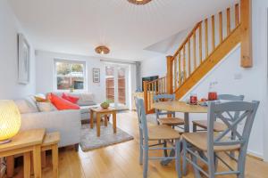 a living room with a couch and a table at Saxon Mews in Wareham