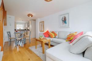 a living room with a couch and a table at Saxon Mews in Wareham +17 photos