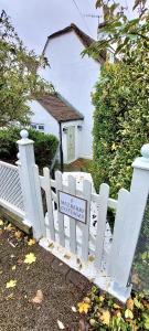 a white picket fence in front of a house at Charming 3 bed kent Cottage in Chilham