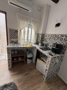 eine Küche mit Spüle und Theke in der Unterkunft El Tumbao con romántica bañera de hidromasaje para dos in Laroya