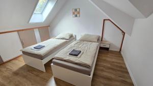 a bedroom with two beds and a window at Dom Hlohovec Center in Hlohovec