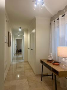 a hallway with a desk and a hallway leading to a room at Apartamento Boutique Centro Histórico in Antequera
