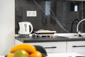 a kitchen counter with a toaster and a sink at Spyridoula House in Corfu