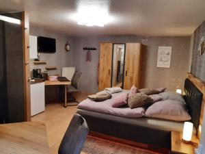 a bedroom with a large bed with pillows on it at Pension Zur Mühle in Nettetal