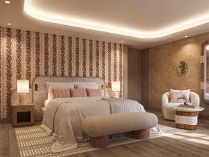 una camera da letto con un letto grande e una sedia di Hôtel de La Fontaine a Lourmarin