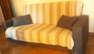 a bed with two pillows on top of it at Sa Domittedda in Sassari +7 photos