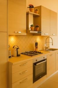 a kitchen with a sink and a stove top oven at Sa Domittedda in Sassari