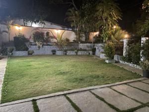 a backyard at night with a grass yard at Penthouse Bandarawela in Bandarawela