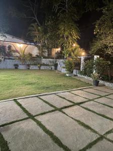 a garden at night with a lawn and lights at Penthouse Bandarawela in Bandarawela +3 photos