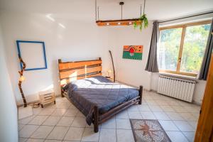 a bedroom with a bed and a large window at La casa in campagna in Cascina Grossa