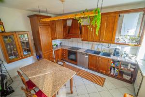 a kitchen with wooden cabinets and a table in it at La casa in campagna in Cascina Grossa