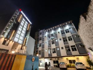 a building with lights on top of it at night at preferred hotel and restaurant in Roorkee