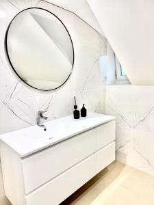 a bathroom with a white sink and a mirror at Room in new a renovated house with modern furniture in Esch-sur-Alzette