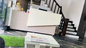 a white bench sitting in front of a staircase at preferred hotel and restaurant in Roorkee