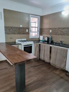 a kitchen with a stove and a counter top at Hornero House in San Antonio de Areco +15 photos