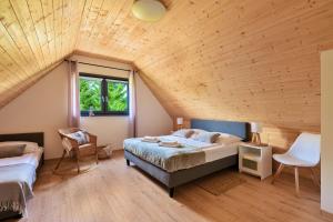 Un dormitorio con una cama grande y un techo de madera. en Dream Home 600m2 EV WiFi600 PlaySt Kominek Las10min, en Polanica-Zdrój