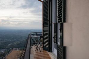 a balcony with a table and a view of a city at Belvedere la Rocca in Rocca dʼArce +7 photos