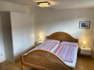 a bedroom with a wicker bed with two lamps at Ferienhaus Mehler - Heiligenhafen in Heiligenhafen