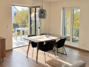 a dining room with a table and chairs and a balcony at WeberHof Appartements in Burg