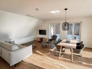 a living room with a couch and a table at WeberHof Appartements in Burg