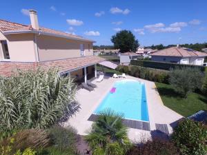 a swimming pool in the backyard of a house at Villa La Hispañola in Arès