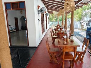 a row of tables and chairs in a restaurant at ANGEL VILLA , Place with nature and care in Midigama West