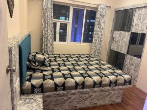 a bed in a room with a window at FAMILY ONLY -No unmarried couple allowed #2 in Thane