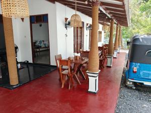 a dining room with a table and chairs and an rv at ANGEL VILLA , Place with nature and care in Midigama West