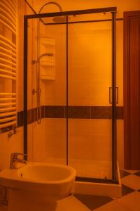 a bathroom with a shower with a toilet and a sink at Sa Domittedda in Sassari