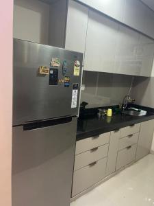 a kitchen with a stainless steel refrigerator and a sink at FAMILY ONLY -No unmarried couple allowed #2 in Thane