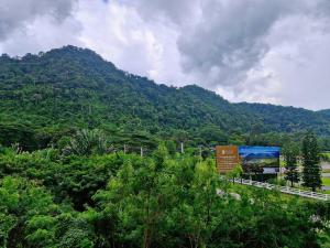 a mountain with trees and a sign in the foreground at Baan Khaoyai by Chateau in Ban Tha Maprang