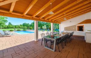 a patio with a table and chairs and a pool at Villa Roberta by Villas Guide in Pazin