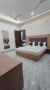 a bedroom with a large bed in a room at Hotel Pilgrim walking distance From Golden Temple in Amritsar