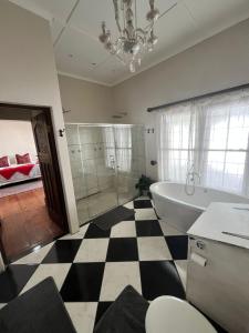 a bathroom with a black and white checkered floor at Toni's Cottage in Graaff-Reinet