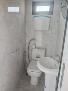 a bathroom with a toilet and a sink at Zeyvə Farm House  +27 photos