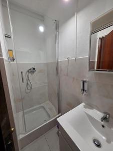 a bathroom with a shower and a sink at Alojamentos Altamira  +34 photos