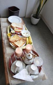 a tray of food on a table with toast and bread at Sithu Guesthouse in Bentota