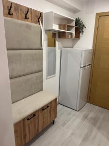a small kitchen with a refrigerator and a table at INNA Studio Rin Residence in Bucharest