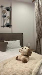 a teddy bear sitting on top of a bed at INNA Studio Rin Residence in Bucharest