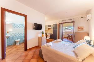 a bedroom with a large bed and a bathroom at Cristal Blu in Santa Teresa Gallura +84 photos