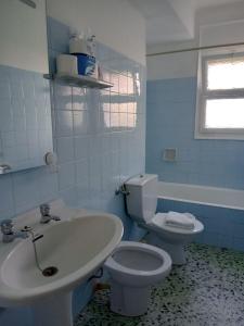 a bathroom with a white toilet and a sink at Tamariua L2, apartamento cerca de la playa del Pas in Port de la Selva +7 photos