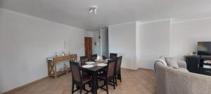 a living room with a table and chairs and a couch at Priai Longa 34 Self Catering in Langstrand